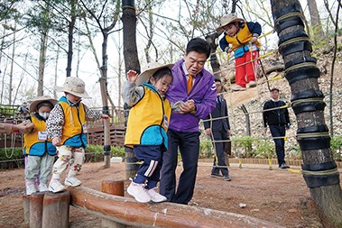 배봉산 자연교육 공간인 유아숲 체험장에서 이필형 구청장이 유아들 체험을 돕고 있는 모습.